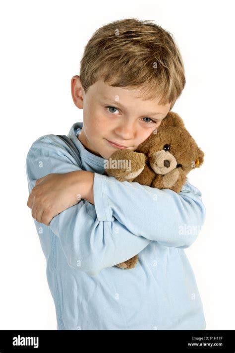 Little Boy Holding A Teddy Bear In His Arms Stock Photo Alamy