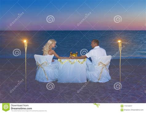 Loving Couple At Romantic Dinner With Torch Flares Candles And Stock