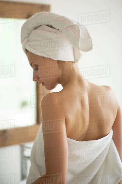 Young Slim Woman Wrapped In White Towel After Taking A Shower Standing