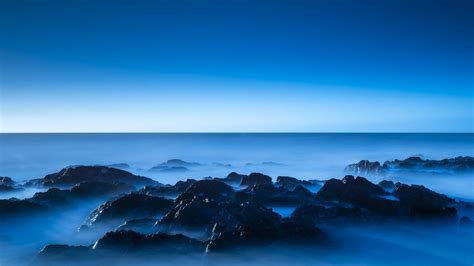 Seascape 4k Wallpaper Blue Horizon Clear Sky Ocean Rocks Sunrise