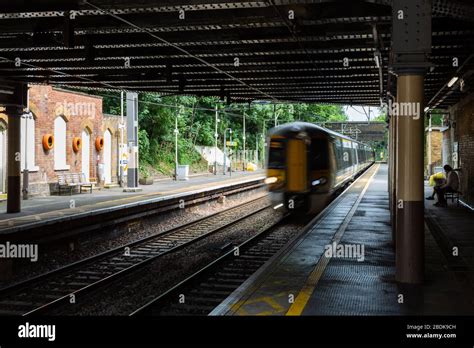 Passengers Wait For Their Overground Train At Clapton Railway Station