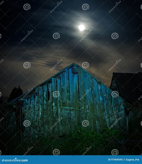 A Spooky Old Wooden Barn At Night Illuminated With Full Moon Stock