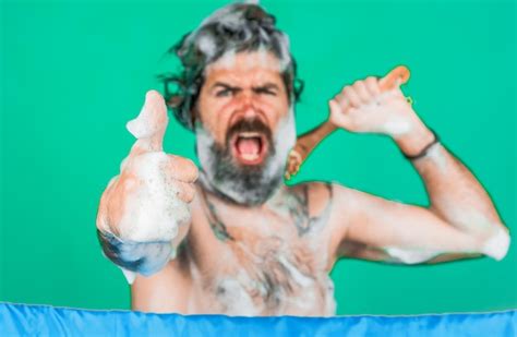 Premium Photo Bearded Man Soaped With Foam Washes In Shower Shows