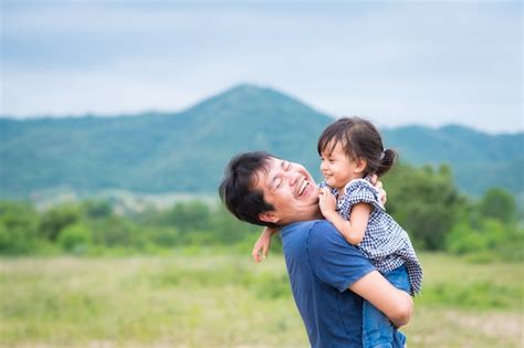 Premium Photo Asian Father And Daughter Are Playing And Laughing Together