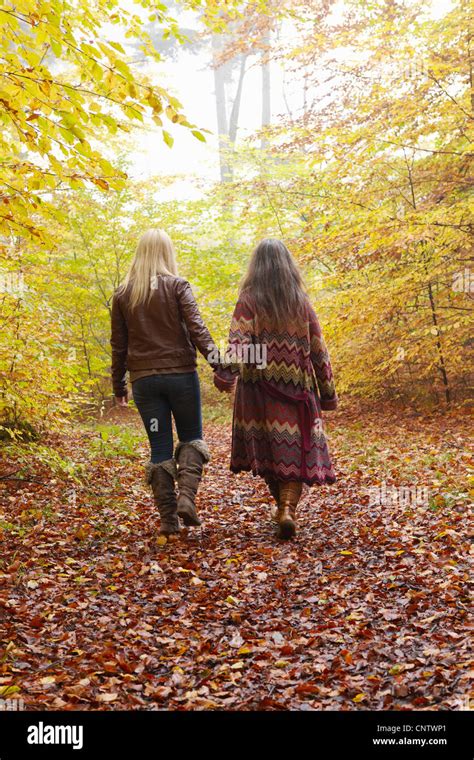 Mother And Daughter Walking In Forest Stock Photo Alamy