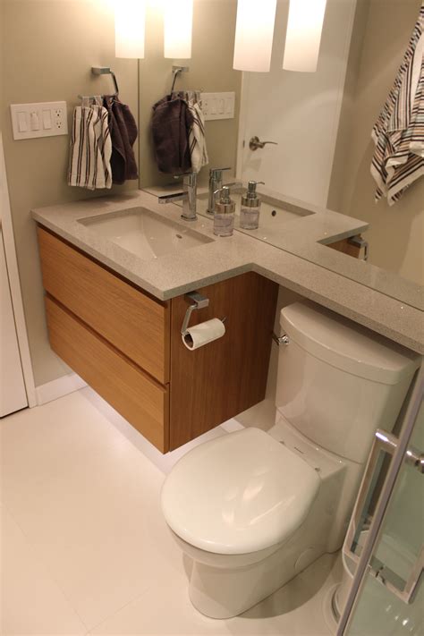This tiny bathroom is made to feel much larger by the inclusion of mirror all around the room. Condo Bathroom Renovation - modern, beautiful and compact ...