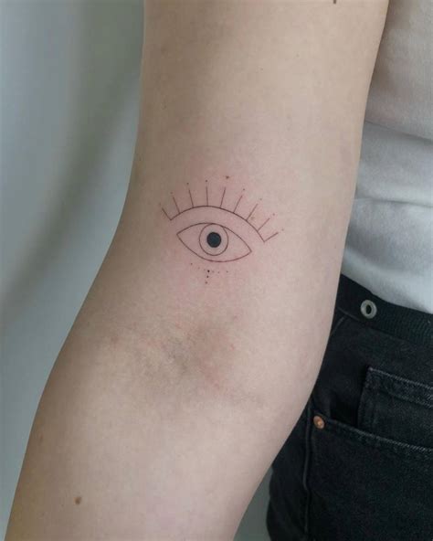 Evil Eye Tattoo Located On The Bicep Minimalist Style