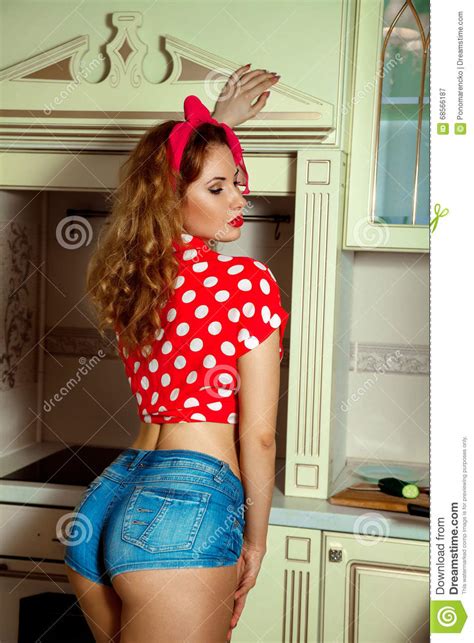 Portrait Of Sexual Woman In Pinup Style Posing On Kitchen Stock Image