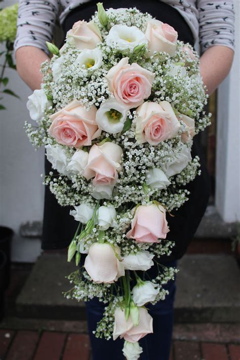 elegant blush pink and white tear drop bouquet including roses lizianthus and gypsophil