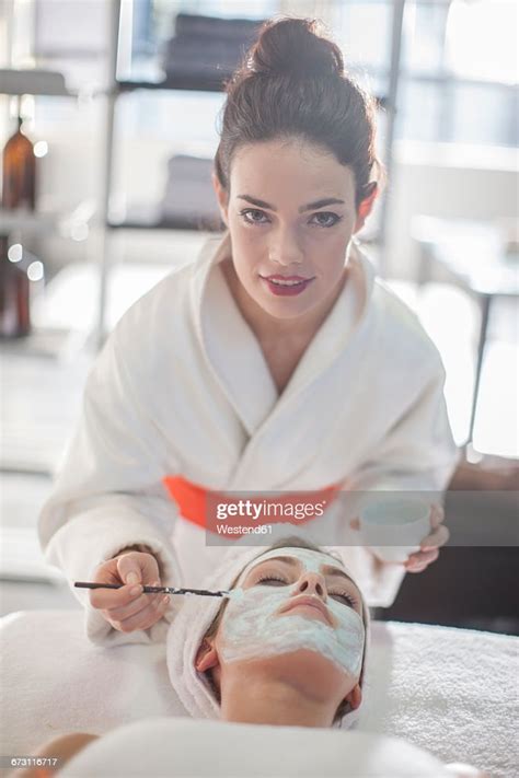 Young Woman In Spa Receiving Facial Mask High Res Stock Photo Getty
