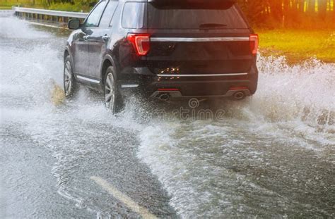 Cars Driving On A Flooded Road During A Flood Caused By Heavy Rain