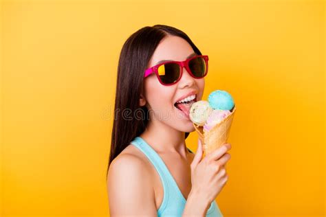 Cheerful Young Korean Lady Licks Tasty Ice Cream Of Three Scoops Stock