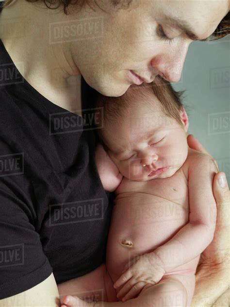 Father Cuddling Newborn Baby Stock Photo Dissolve