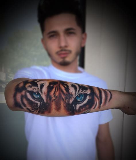 A Man With A Tiger Tattoo On His Arm