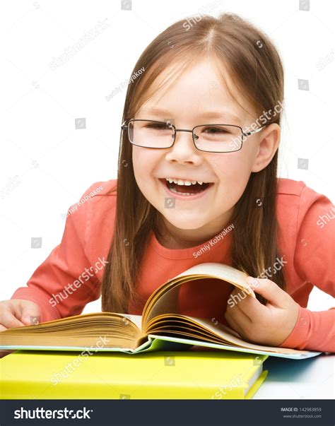 Cute Little Girl Reading Book While Stock Photo 142983859 Shutterstock