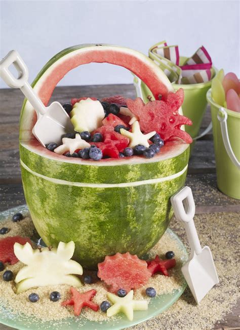 Fruit Salad Served In Watermelon Basket With Sand Bucket Shovels As