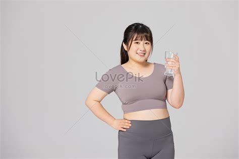 fat female wearing fitness clothes holding a glass picture and hd photos free download on lovepik