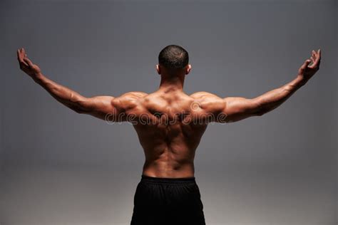 Male Bodybuilder Raising His Arms Back View Stock Photo Image Of