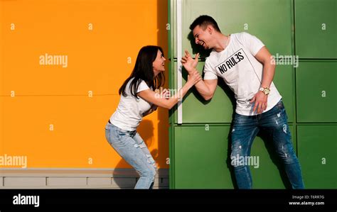 Young Couple In Love Hiding From Each Other The Girl Scared The Guy Jumping Out From Around