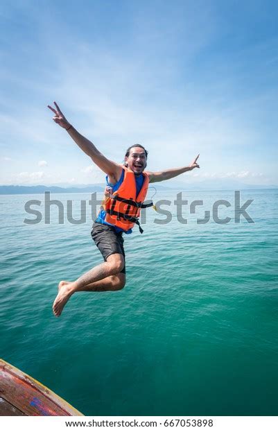 Man Jumping Boat Into Seaandaman Seathailand Stock Photo