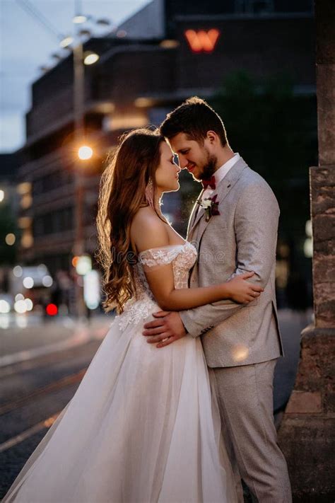 Beautiful Bride And Groom Embracing And Kissing On Their Wedding Day