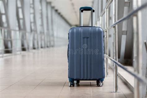 Closeup Shot Of Stylish Cabin Baggage Suitcase Standing In Empty