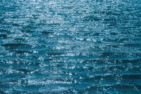 Blue Water Surface With Sun Glare Marine Background Texture Stock