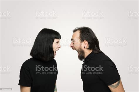 Young Couple Yelling At Each Other In Studio Stock Photo Download