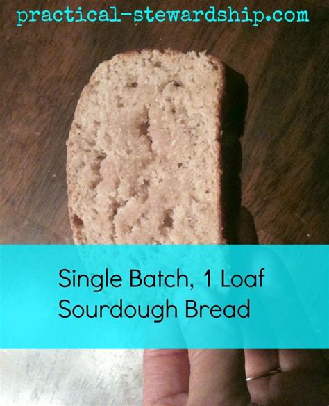 A Hand Holding A Piece Of Bread On Top Of A Wooden Table With The Words Single Batch 1 Loaf