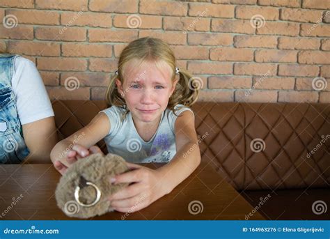 Blond Crying Teen Girl With Long Hair And Blue Eye Stock Photo