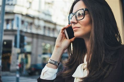 businesswoman making a phone call on the street by lumina business women professional women