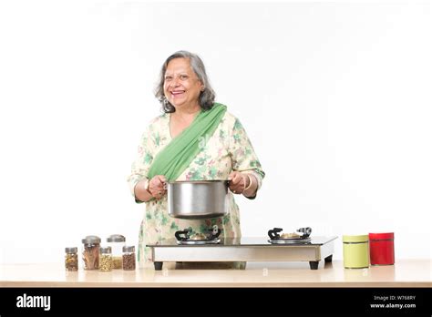 Indian Old Woman Cooking Food In Kitchen Stock Photo Alamy