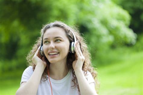 Beautiful Young Woman Listening To Music In A Park Stock Photo Image