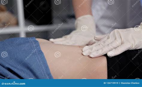 Pediatrician Doing Abdominal Examination With Hands Doctor Checking Stomach Of Sick Girl Stock