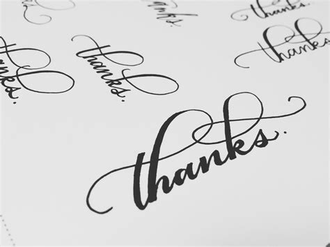 The Word Thanks Written In Cursive Writing On A Sheet Of Paper
