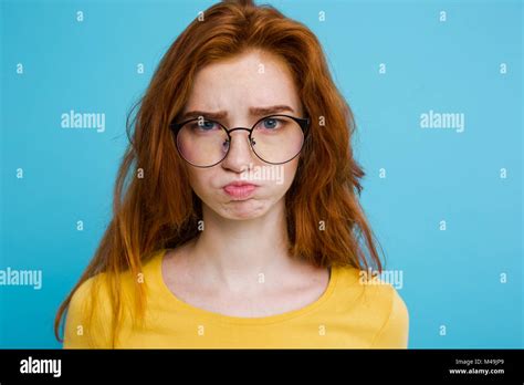 Headshot Portrait Of Tender Redhead Teenage Girl With Serious Expression Looking At Camera