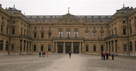 People Are Standing In Front Of A Large Building