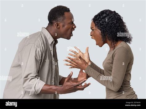 Angry Black Man And Woman Fighting Over Grey Background Stock Photo Alamy