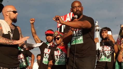 black lives matter activist speaks on stage at pro trump rally