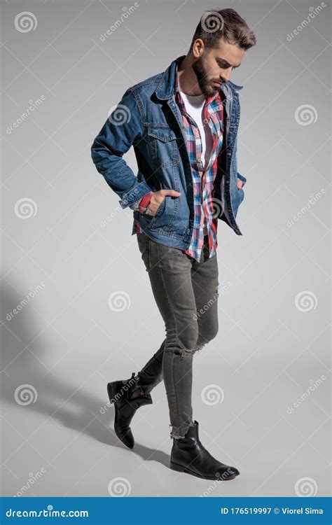 Casual Guy Walking With Hands In Pocket And Looking Down Stock Image