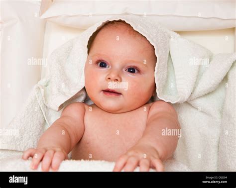 Infant Creaming Face On White Towel Stock Photo Alamy