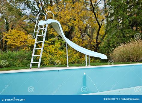 Backyard Swimming Pool With Pool Slide Emptied Out Shutting Down For