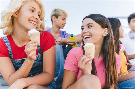 Group Of Happy Friends Multiracial Teenagers Eating Ice Cream Talking