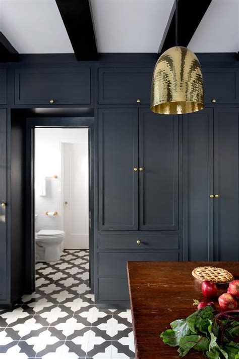 Another bathroom with wooden materials in it from wooden flooring to the walls. Floor to Ceiling Black Kitchen Cabinets with Brass Knobs ...