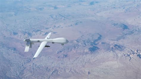 (us air force photo/suzanne increased concern over the rising threat of al qaeda, however, led to arming the predator with. A Predator Drone Flying At High Above The Clouds ...