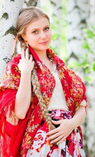 traditional russian picture birch trees a blonde girl with a long plait and pavlovsky posad