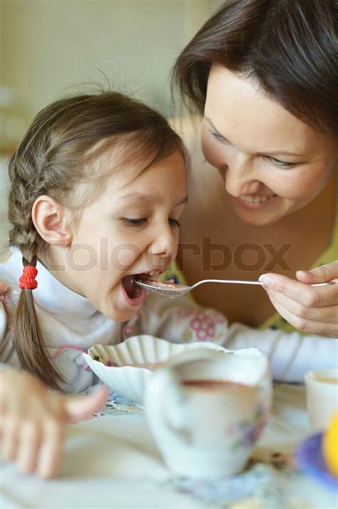 mother and daughter eating stock image colourbox