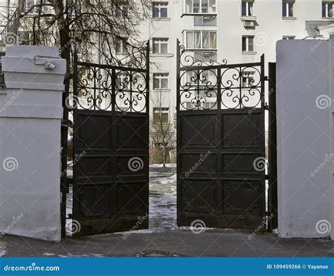 Old Black Metal Entrance Gate Leading From The Street To The Courtyard