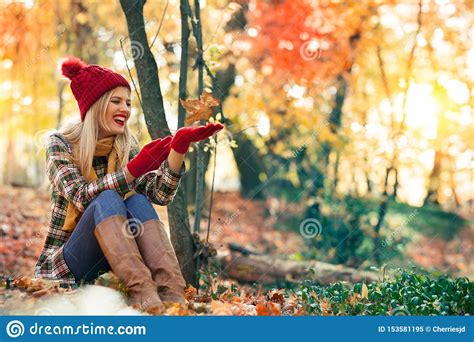 Cute Smiley Woman Holding Autumn Leaf On The Palm In The Nature Stock