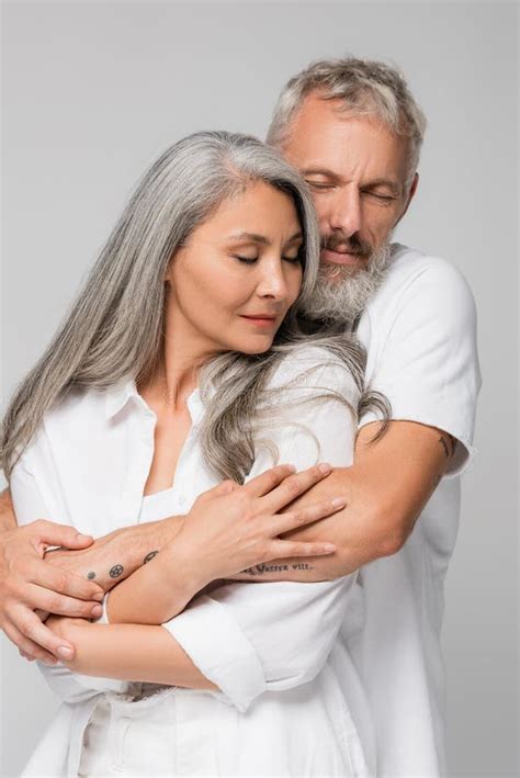 pleased interracial and mature couple hugging stock image image of interracial together